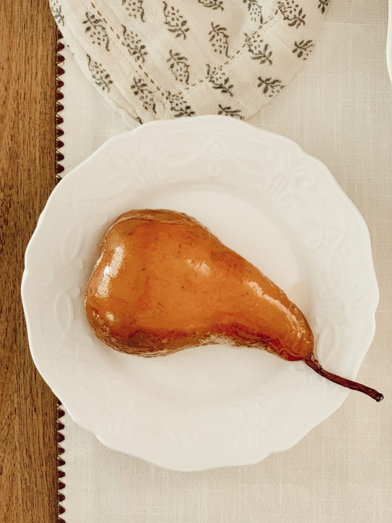 Roasted pears on a summer table with homemade ice cream.