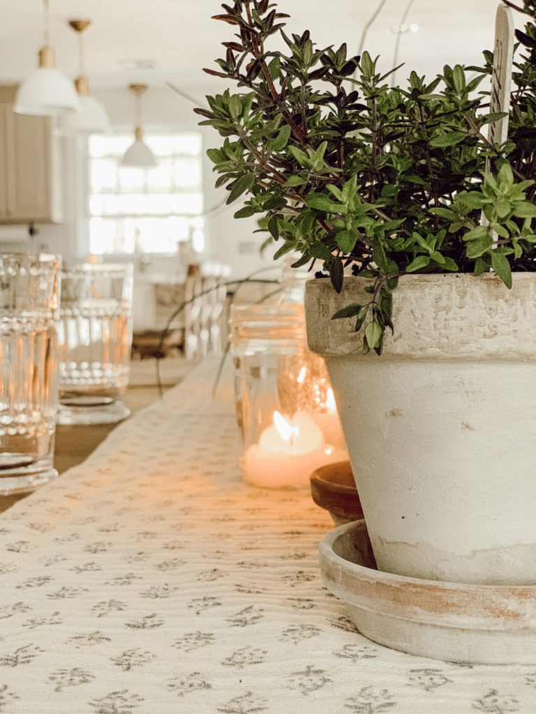 Mother's Day table decorations include fresh herbs & aged terracotta pots.