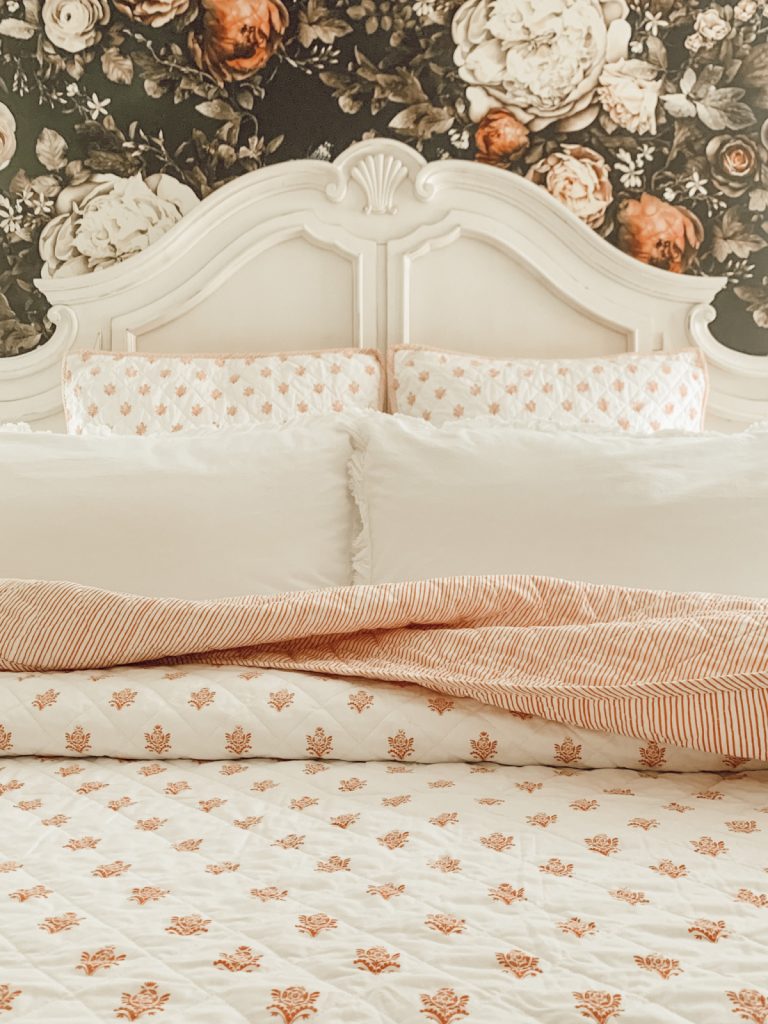 Floral summer bedroom in a cottage farmhouse style home.