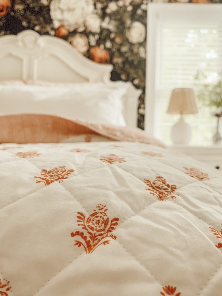 Pink and white floral bedding for a cozy summer sleep.