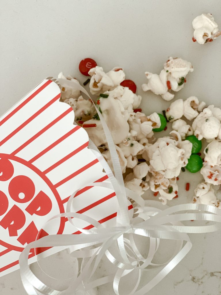 Christmas in July snack with popcorn, chocolate, and candies.