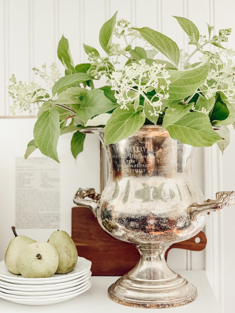 A large silver urn looks beautiful in a cottage farmhouse kitchen.