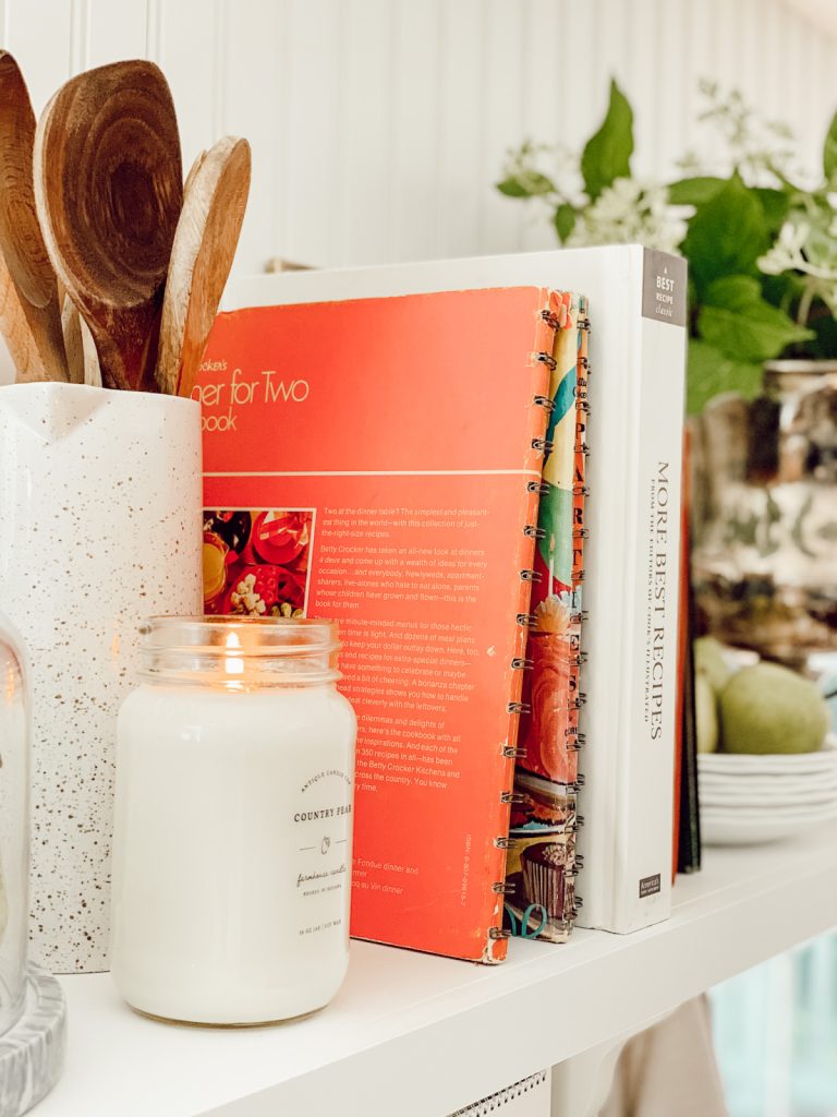 Mix materials on open kitchen shelving for a cozy feeling.