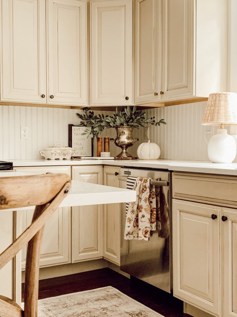 Farmhouse kitchen decorated for fall with decorative items.