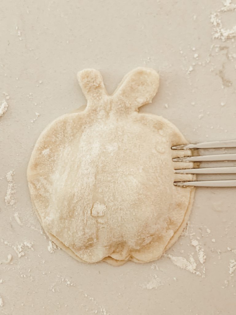 Crimp the edges of the handheld pies together with a fork.