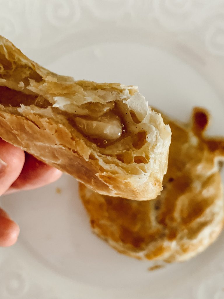 The inside of a fully cooked handheld apple pie for dessert.