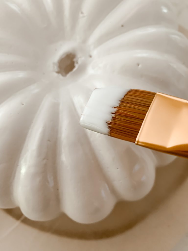 Painting the pumpkin with mod poodle to apply paper napkins.