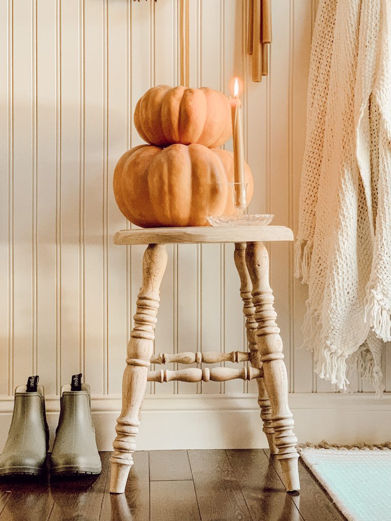 Farmhouse stool with pumpkins for cozy fall home decor.