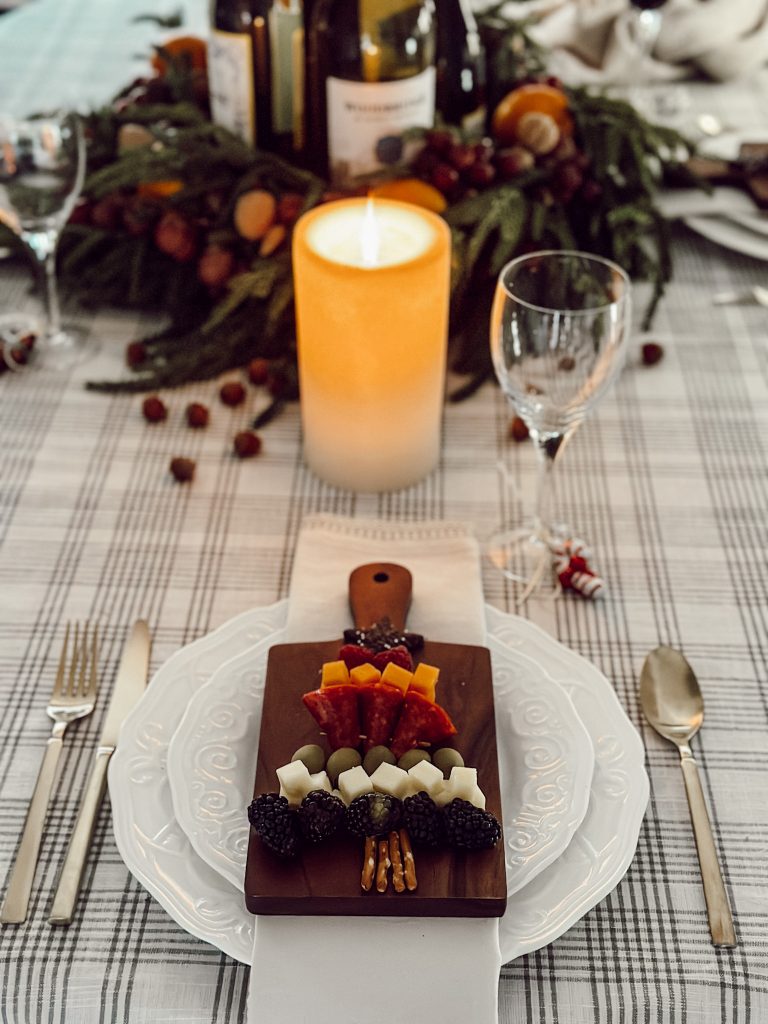Small dinner party charcuterie board placed at each place setting.