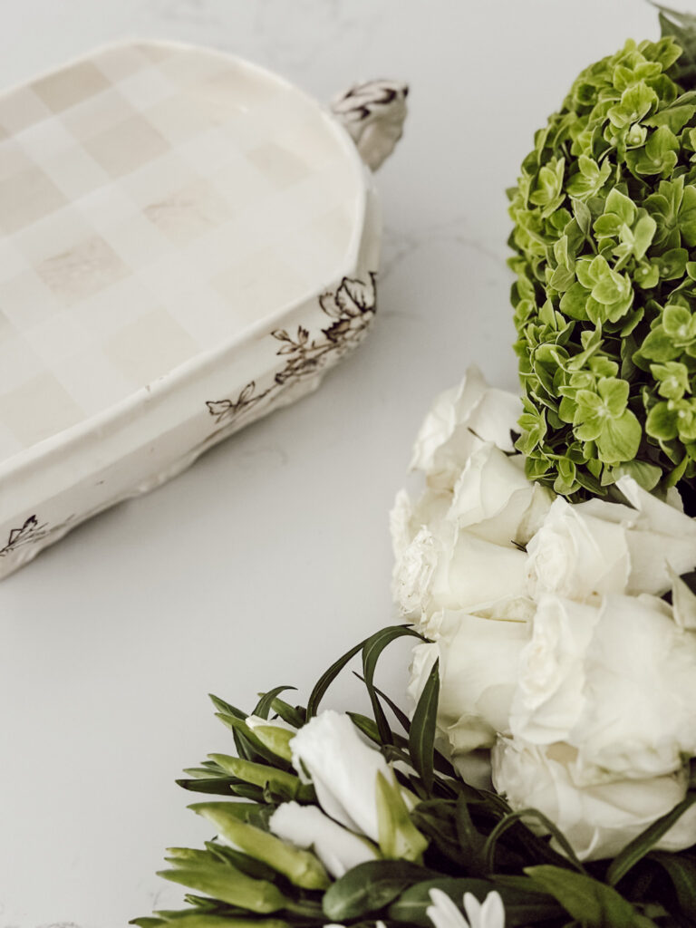 Supplies you'll need to create a flower arrangement include a soup tureen and fresh flowers from the grocery store.