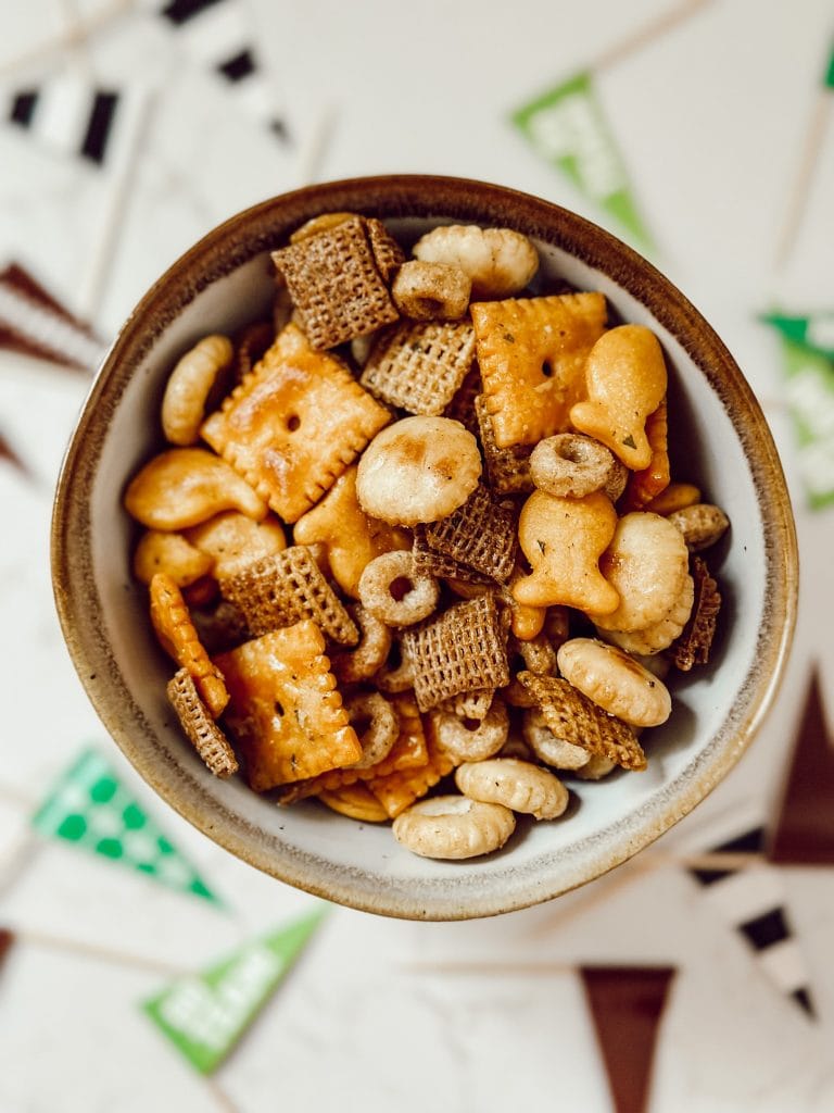Football season party food with cheese crackers, goldfish, and Chex cereal.