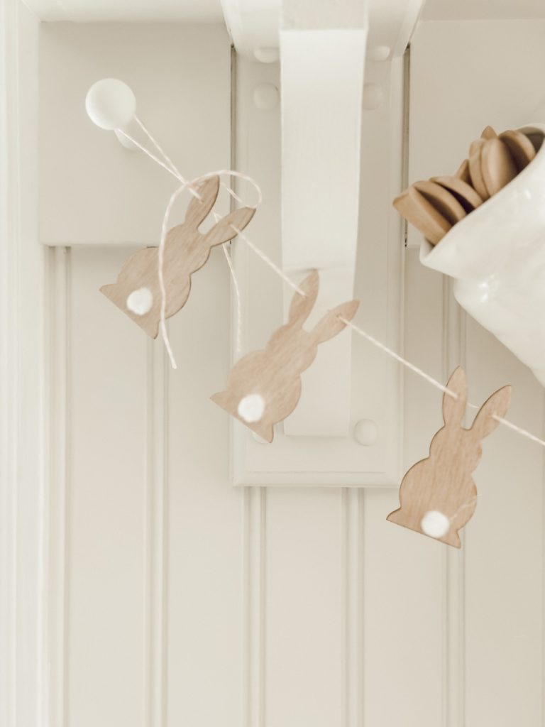 DIY Easter bunny garland hanging on farmhouse kitchen shelf.