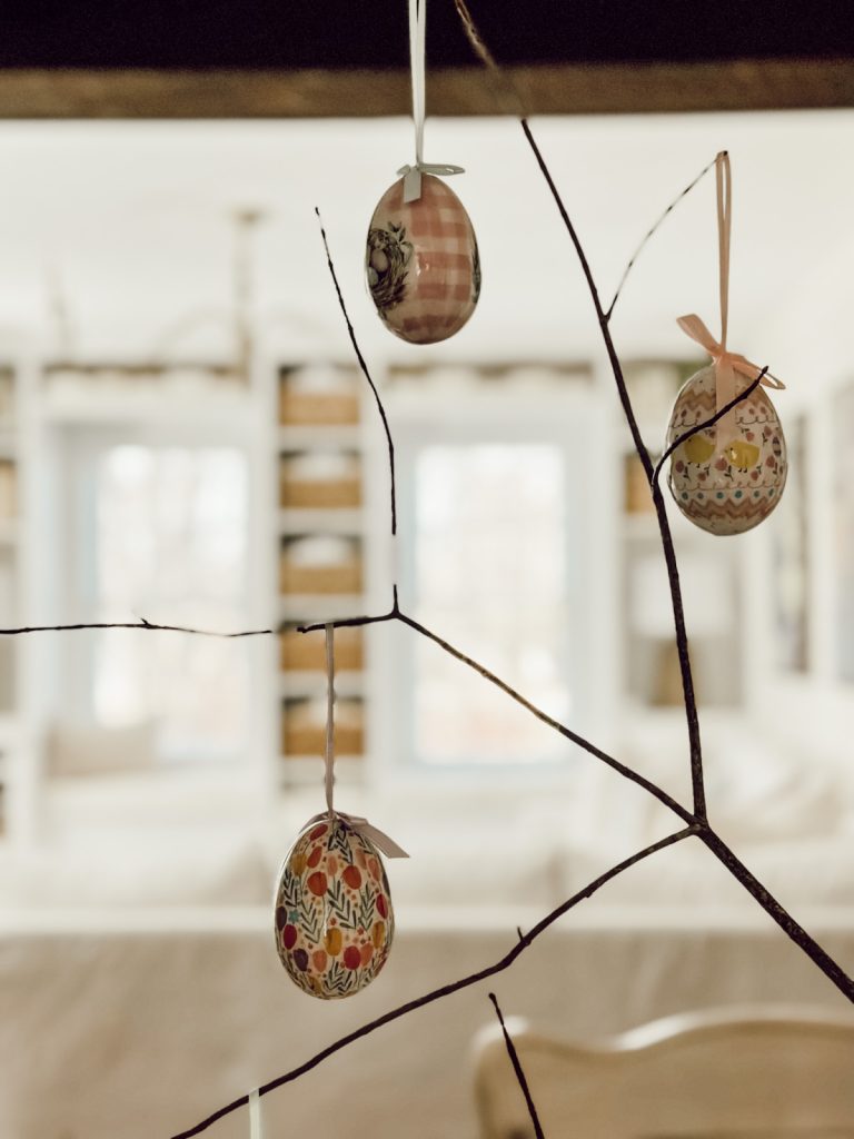 Branches with egg ornaments to create an Easter egg tree.
