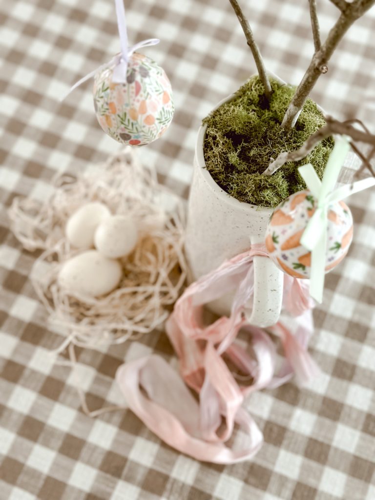 How to create an Easter egg tree with a pitcher, moss, and eggs.