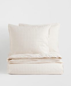 Neutral gingham bedding for a country farmhouse bedroom.