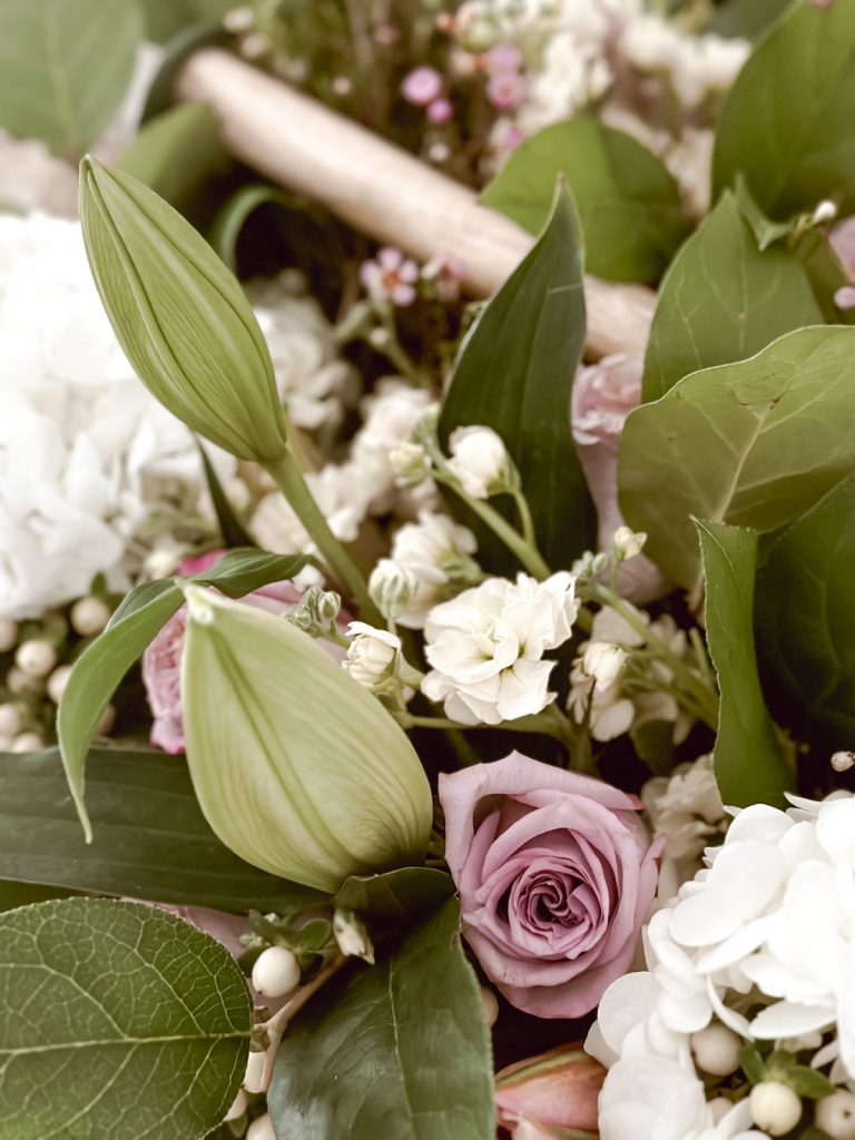 Spring flowers in a garden caddy for Easter home decor.