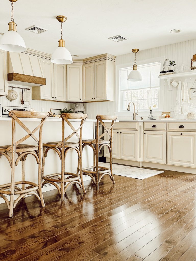 Country kitchen with wood accents & white beadboard walls.