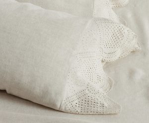 Lace trimmed sheets that are beautiful in a cottage farmhouse bedroom.