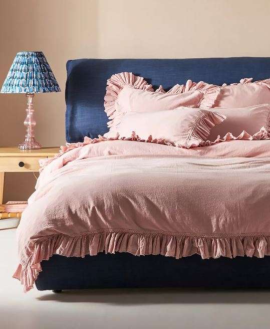 Pink comforter for a cozy cottage bedroom.