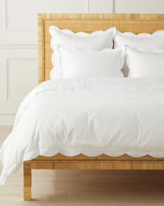 White scalloped bedding is beautiful in a cottage style bedroom.
