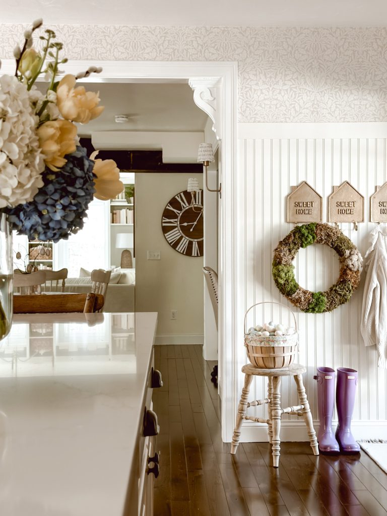 DIY moss wreath hanging on hooks in cottage farmhouse kitchen.