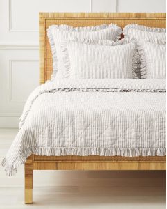 Ruffled striped bedding for a cozy farmhouse bedroom.