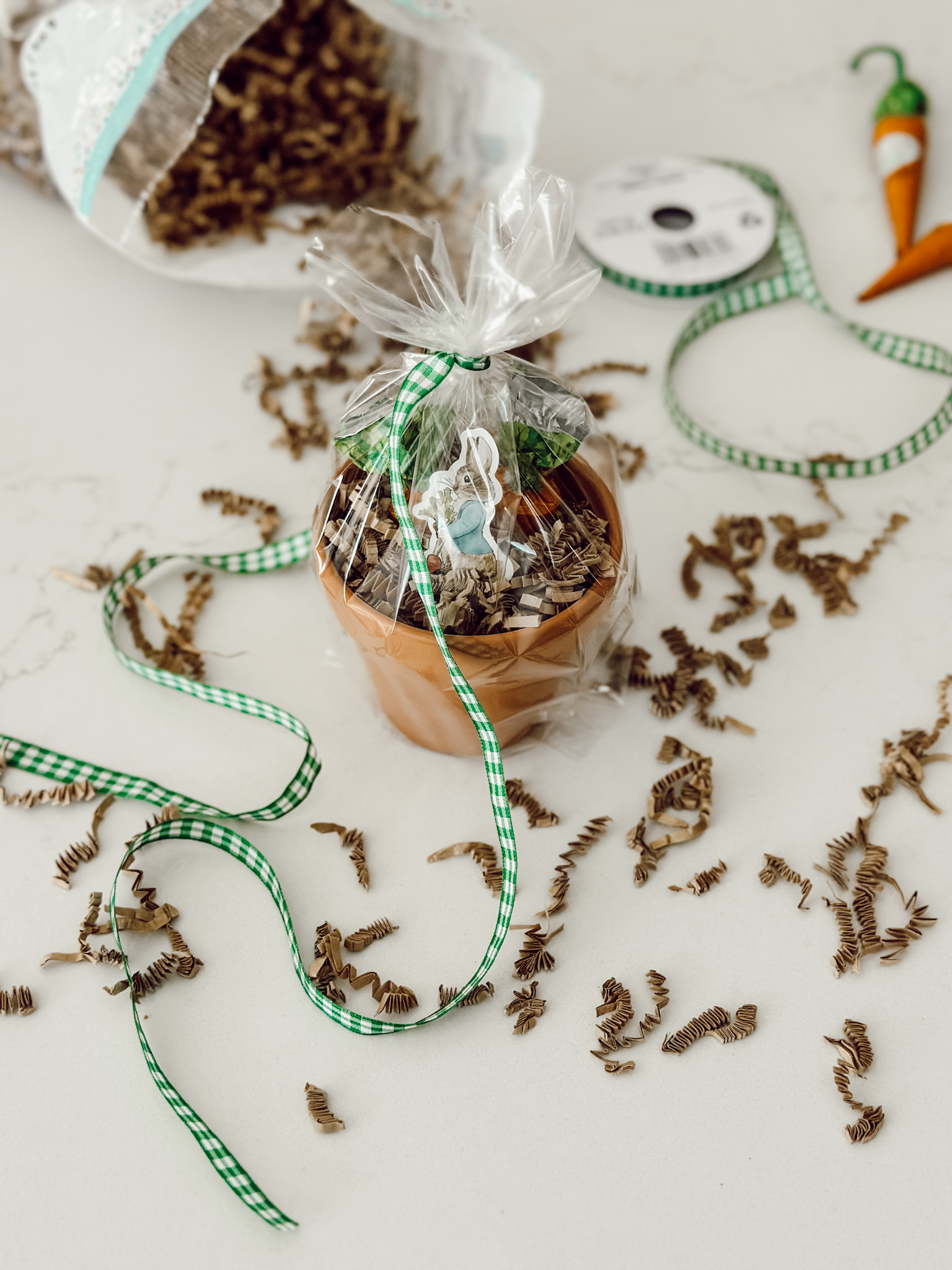 Place the filled flower pot inside of a cellophane bag and tie with gingham ribbon.