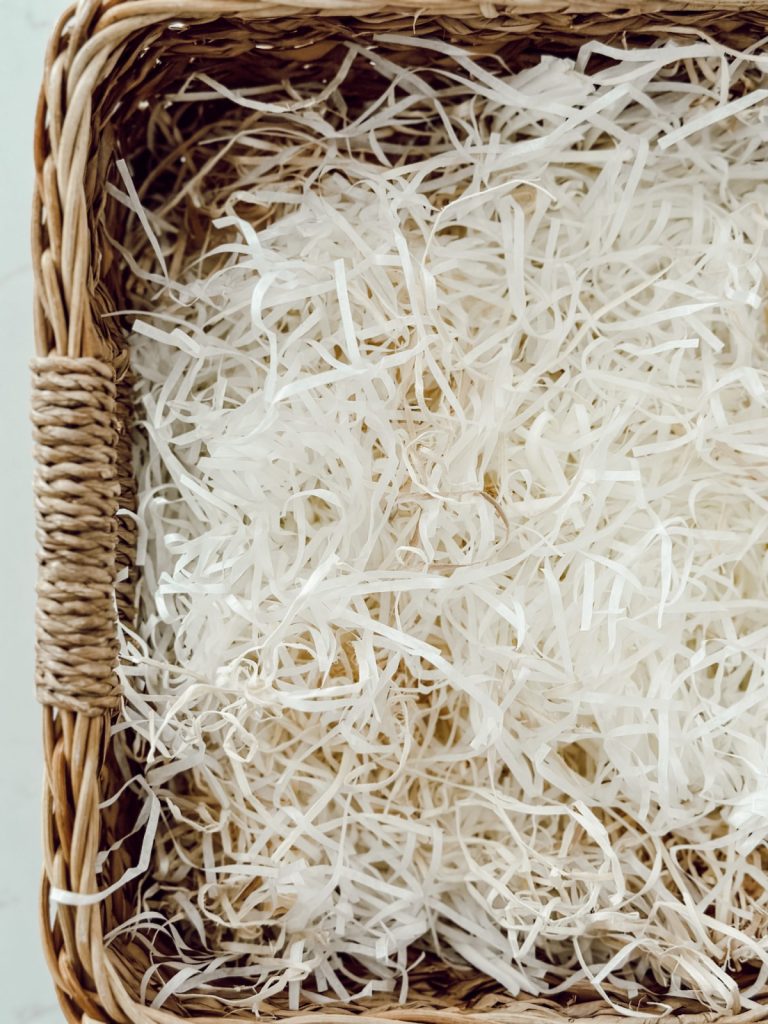 Start a gift basket for mom with shredded paper.