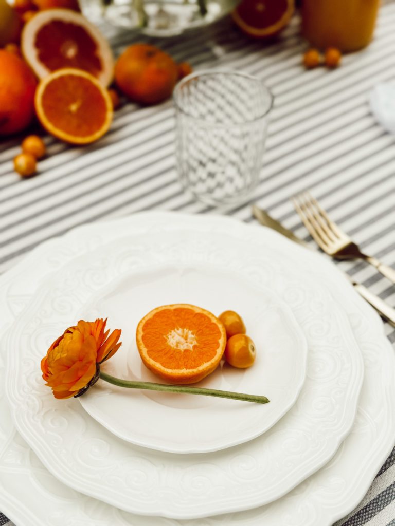 Mother's Day table setting with fresh citrus and pops of blue.