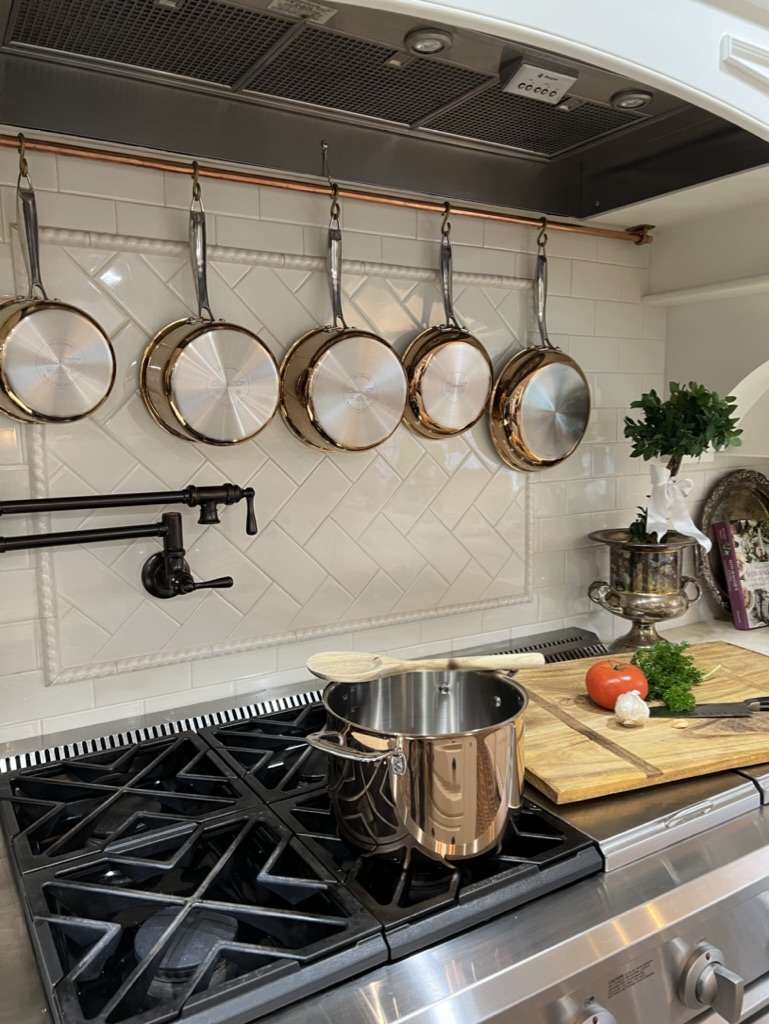 DIY Kitchen decor with a copper pot rack in a French country kitchen.