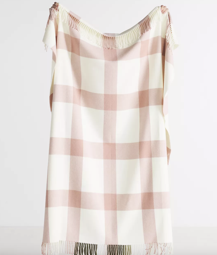 Plaid throw blanket ideal for cuddling on the couch on a cold day.