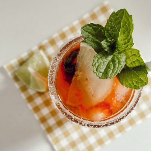 Strawberry mojito mocktail combines strawberries, mint, & lime.