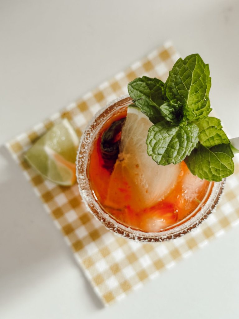 Strawberry mojito mocktail combines strawberries, mint, & lime.