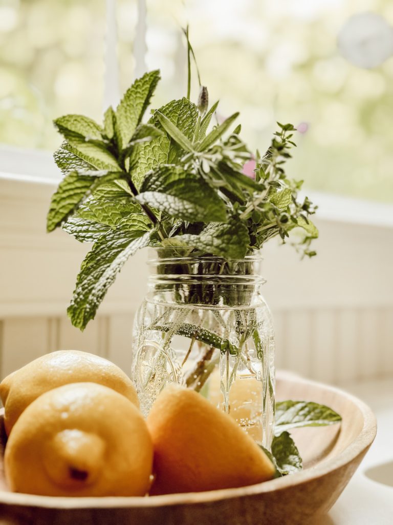 Fresh herbs and lemons in a cottage farmhouse kitchen.