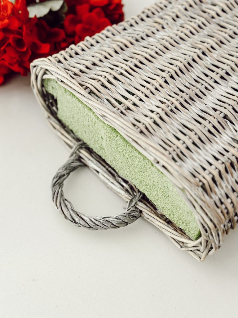 Adding floral foam to a cottage farmhouse hanging vessel.