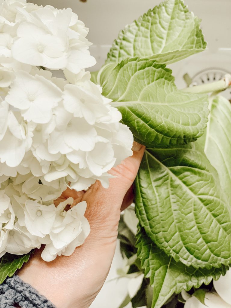 Remove the leaves of cut hydrangeas to allow the blooms to soak up more water.