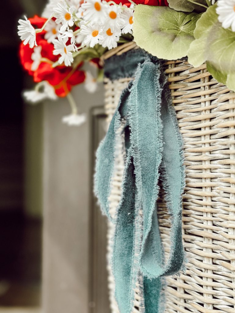 A blue ribbon on a patriotic basket for the front door.