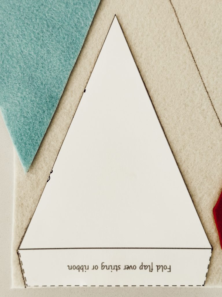Use a template to cut out flag shapes for patriotic DIY flags.