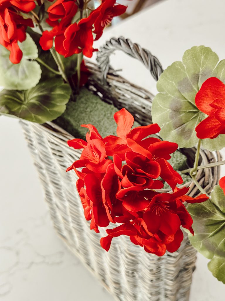 Add geranium stems to hanging basket with shorter ones in front. 