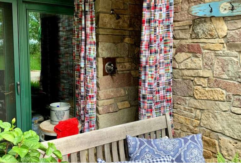 DIY outdoor shower curtain is an affordable option for an outdoor shower.