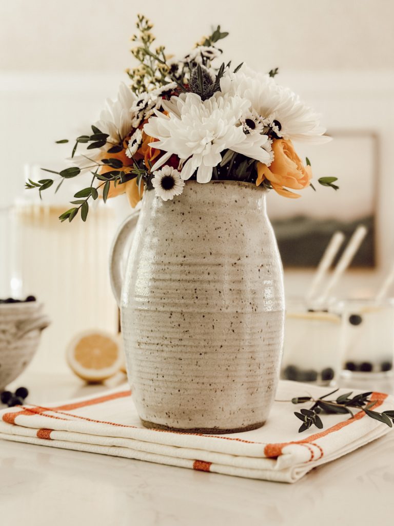 Lemonade and flowers are both functional kitchen decor items.