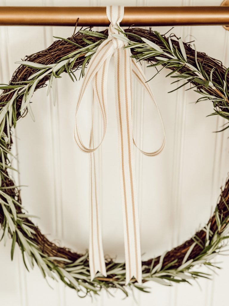 Natural wreath with fresh herbs, grapevine, and ribbon.