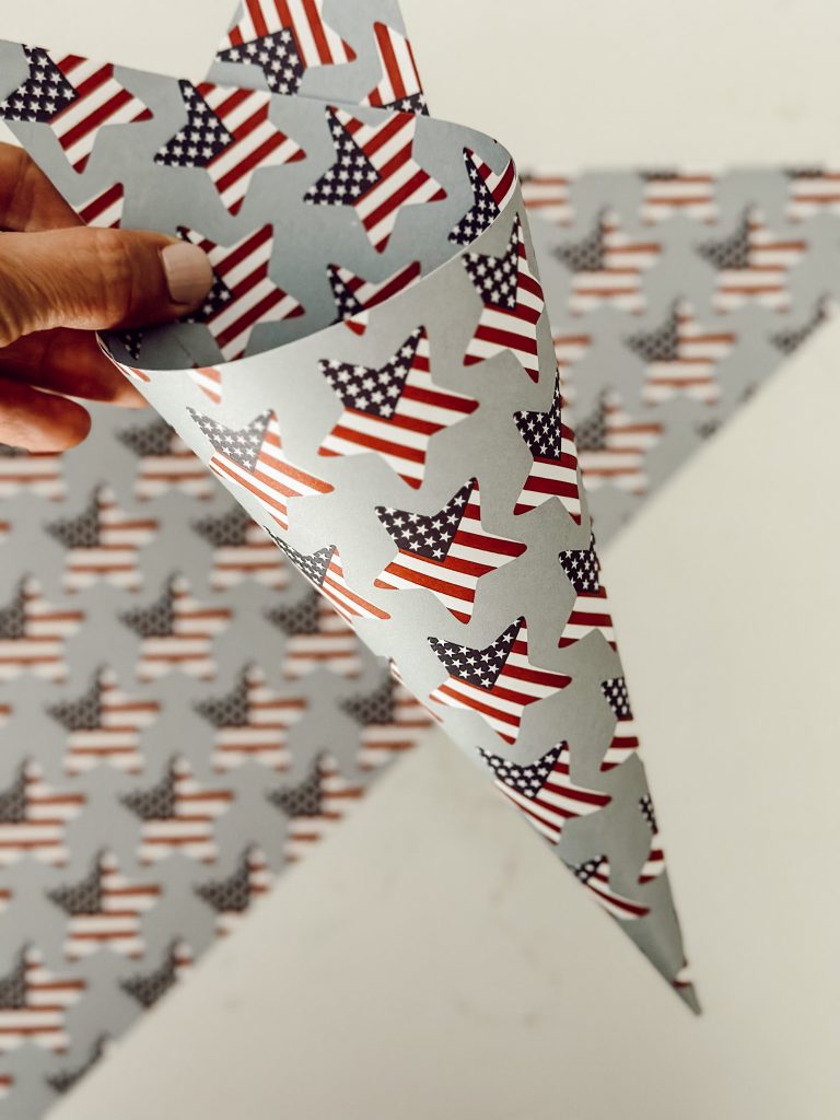 Roll the scrapbook paper into a cone to create the paper basket the party favors will sit inside.