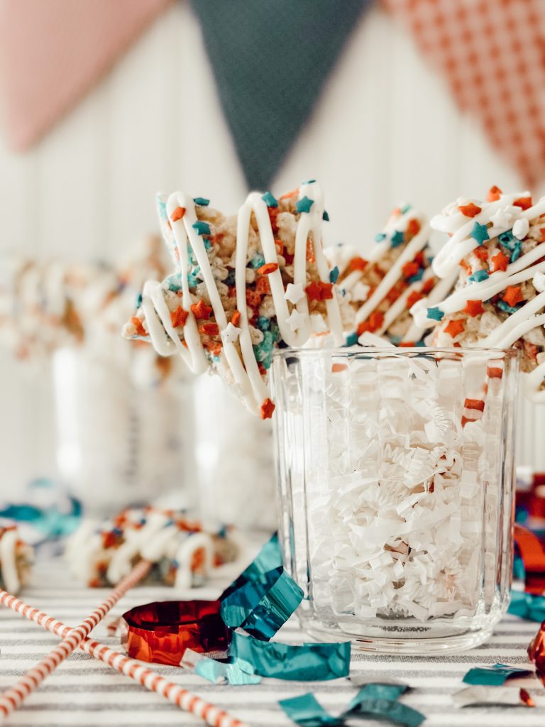 Easy summer dessert in red, white, and blue colors with Rice Krispie cereal, marshmallows, butter, white chocolate, and sprinkles.