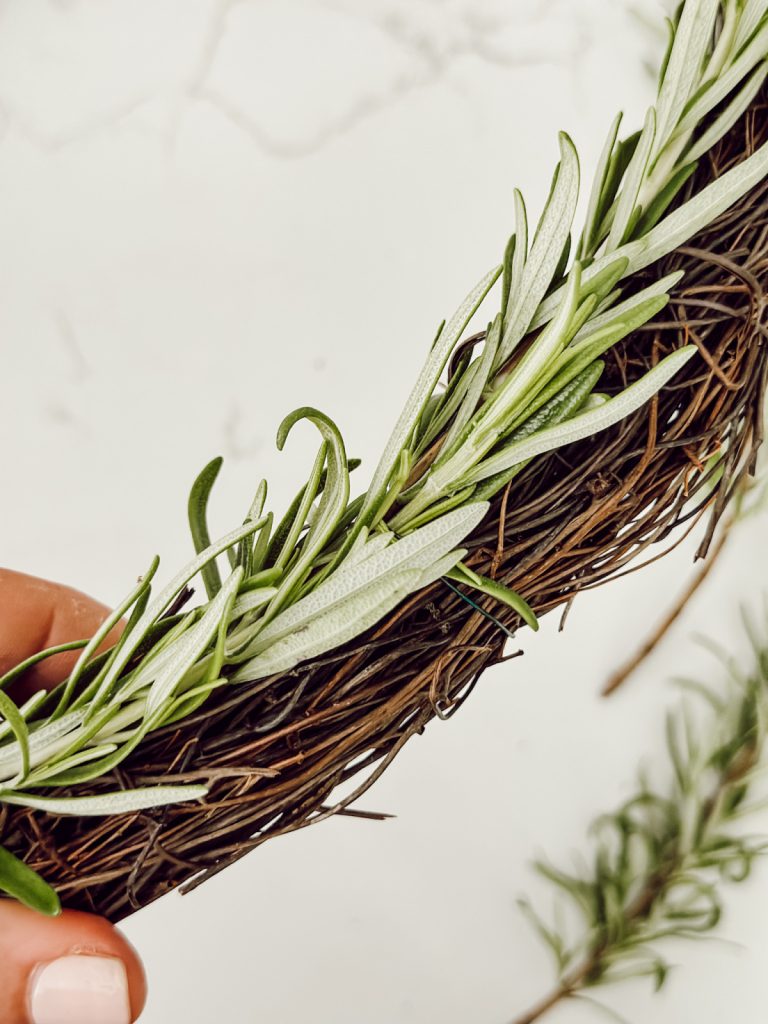 Rosemary tied to grapevine wreath to create rustic home decor.