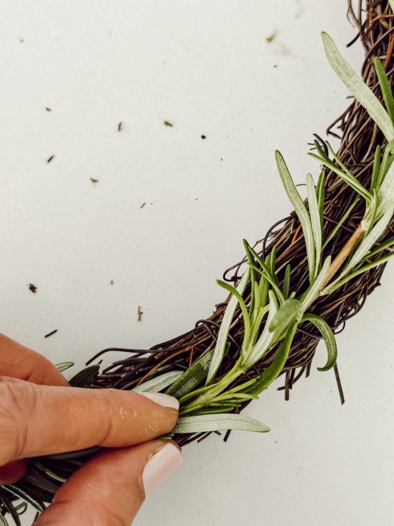 Tie fresh rosemary to wreath with wire to create a DIY rosemary wreath.