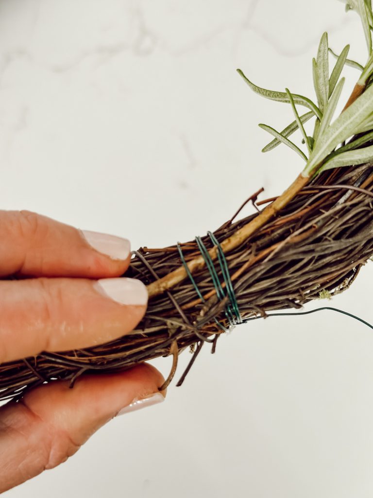 Tie fresh rosemary on wreath form with florist wire.