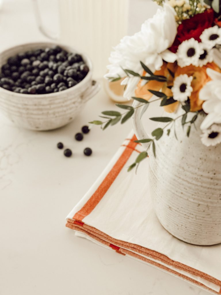 Seasonal decor in the kitchen with blueberries and flowers.