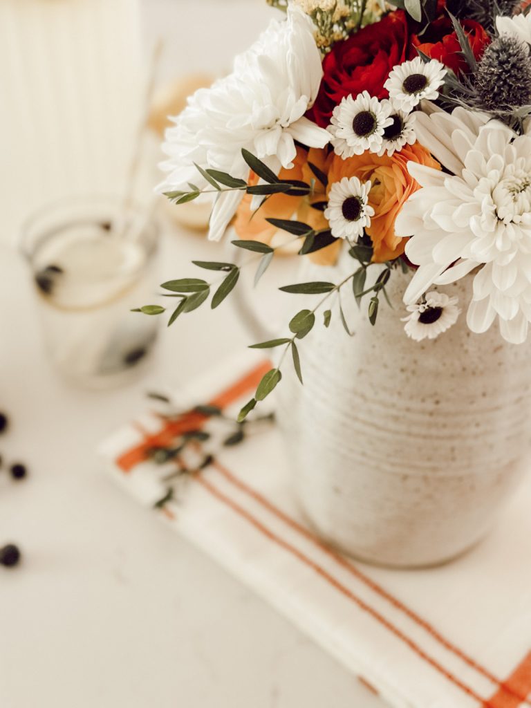 Summer decor with flowers in farmhouse style kitchen.
