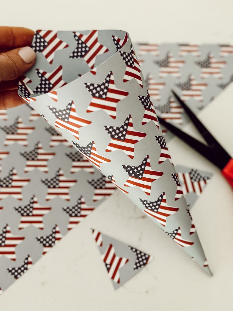 Trim the access craft paper with sharp scissors to create the paper basket for the party favor.